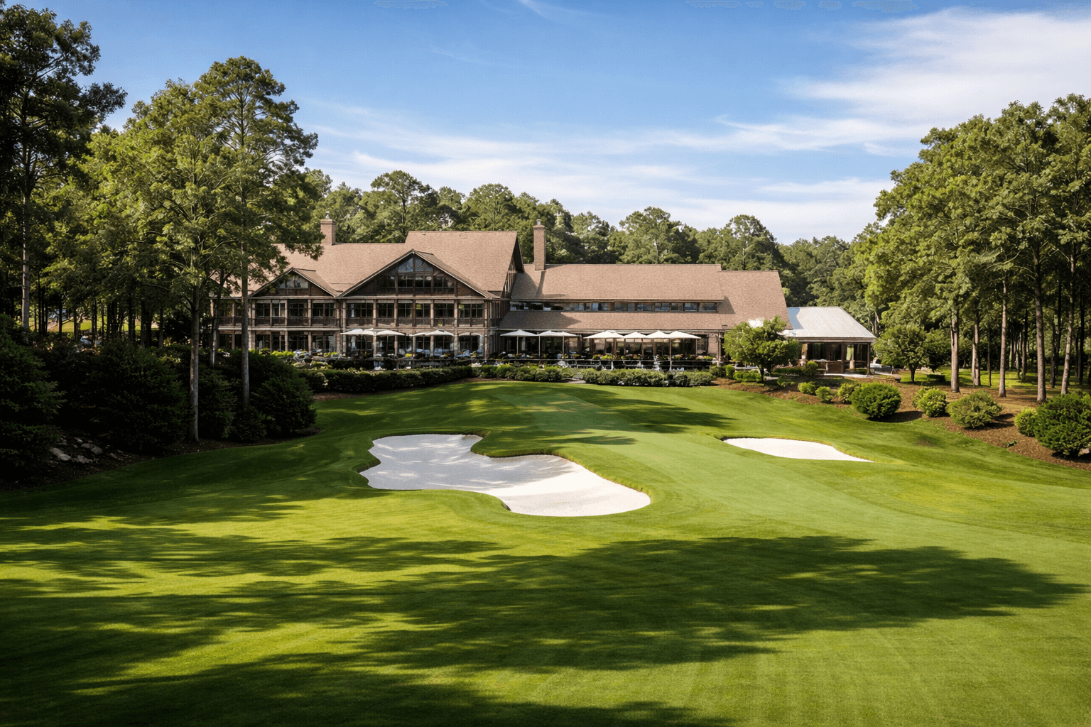 Private golf clubhouse and manicured course with bunkers in Johns Creek, Georgia — the city's country-club character