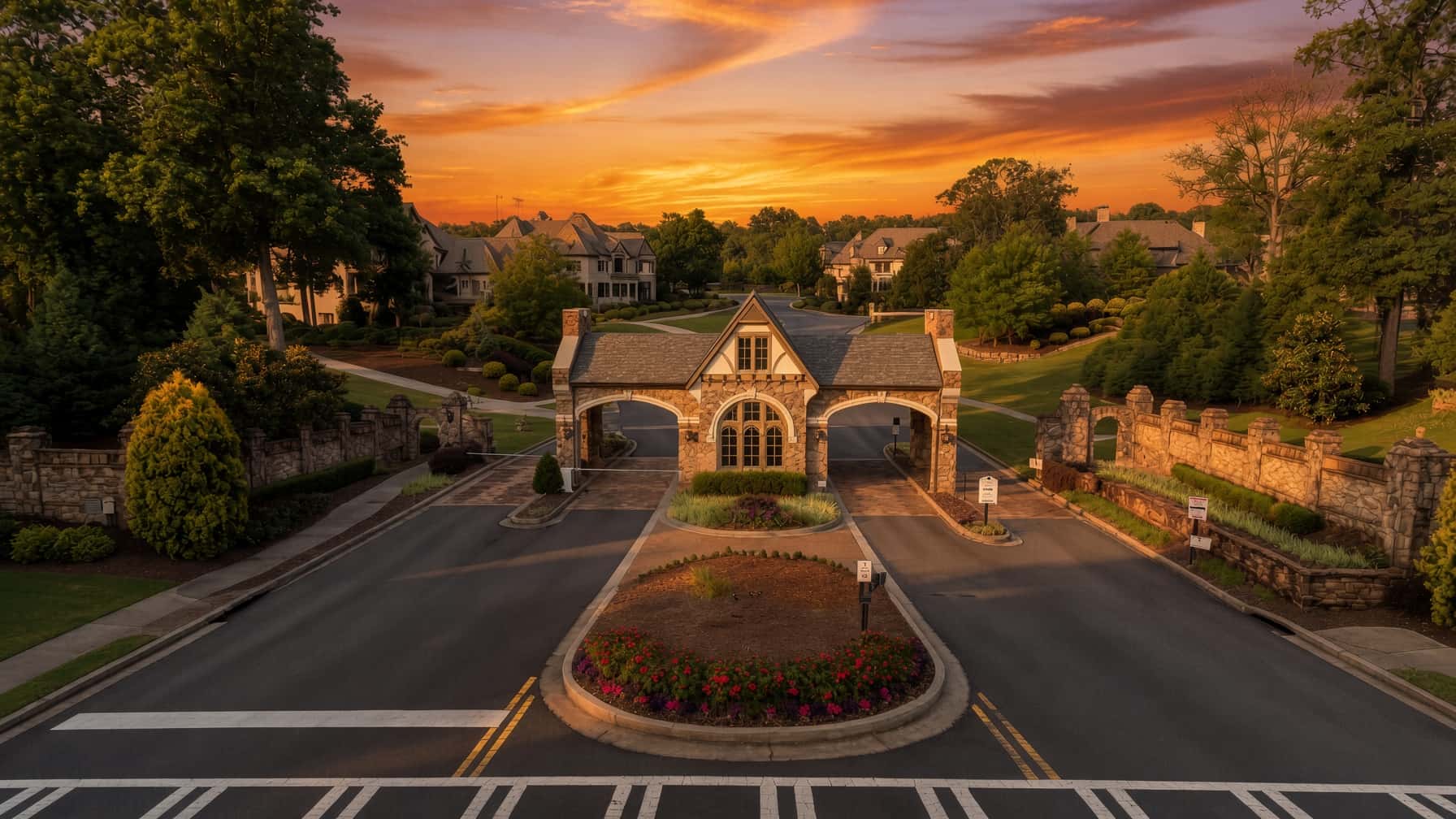 Stone gatehouse at the entrance to a guarded luxury community in Milton, Georgia, at sunset