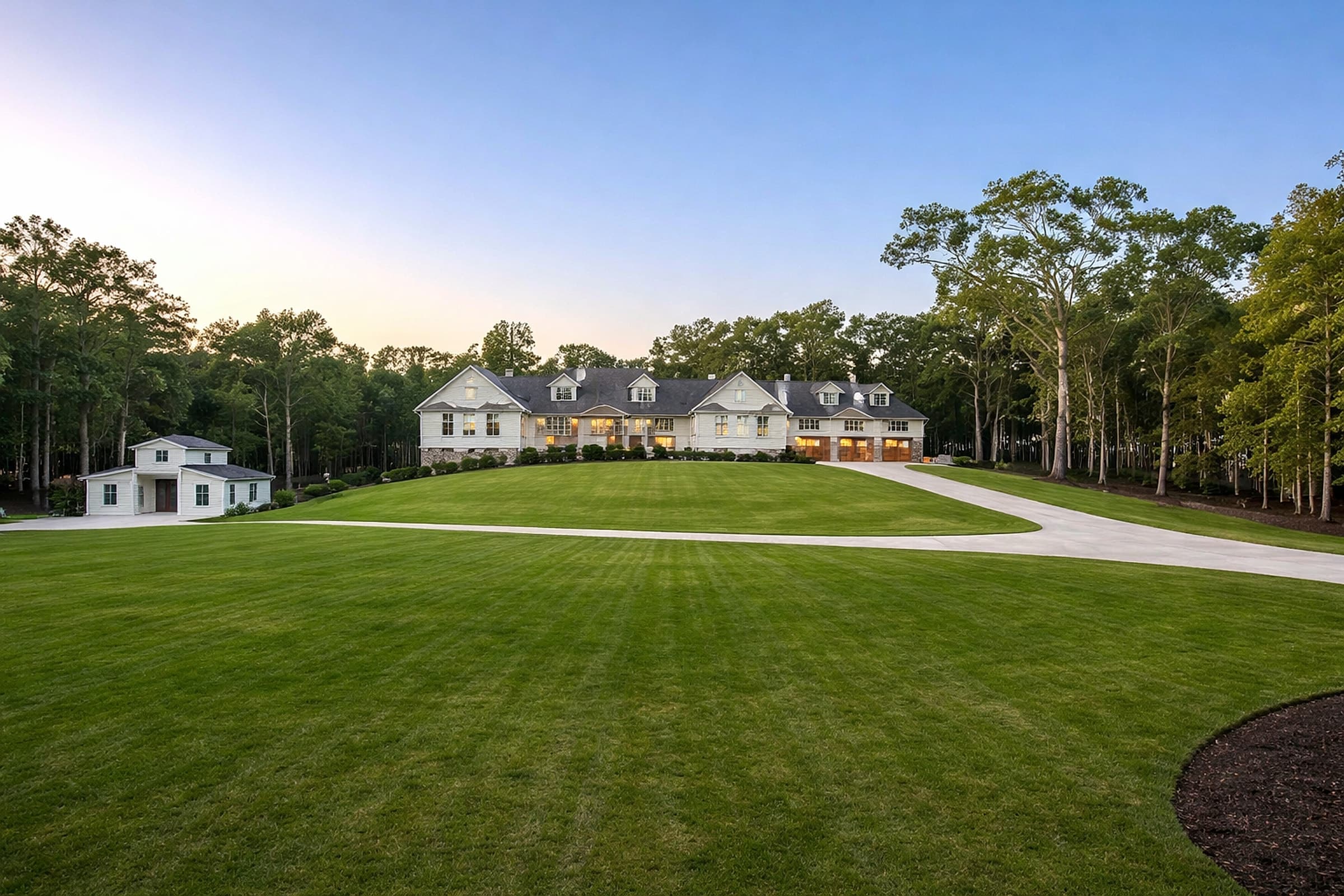 A sprawling North Atlanta luxury estate on manicured acreage at dusk