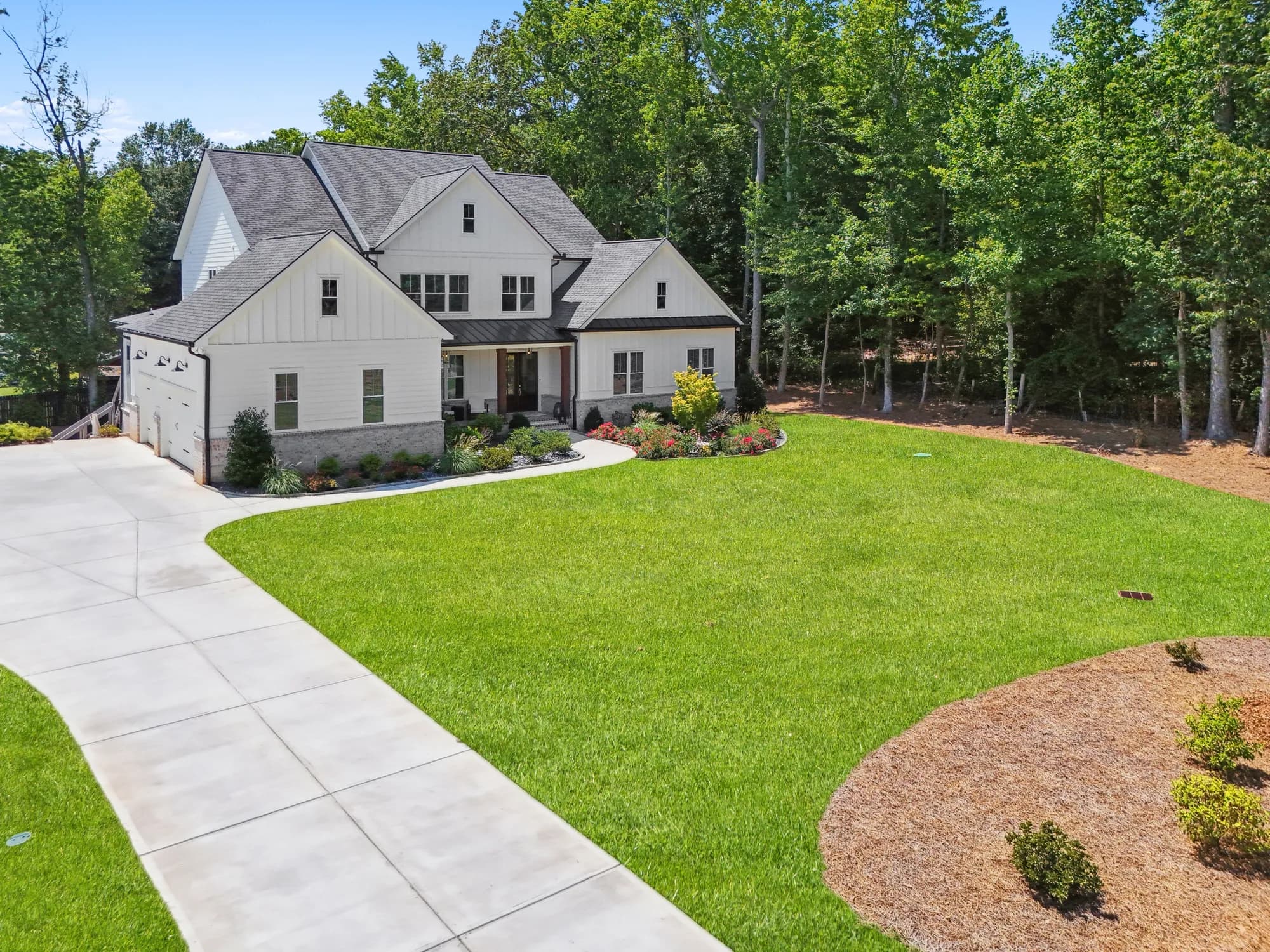 The home on its 1+ acre homesite with mature front-yard landscaping